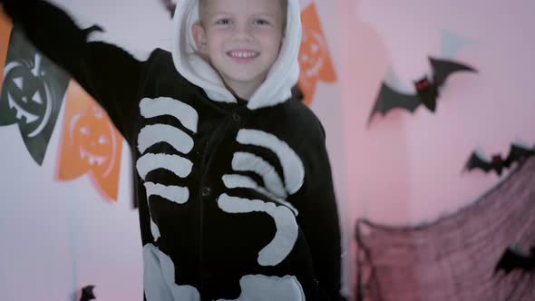 Halloween Kids Happy Dancing Boy in Halloween Skeleton Costume at Home