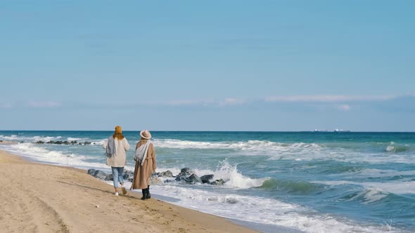 Beautiful Girls Walk Near the Sea