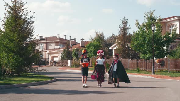 Kids in Halloween Costumes Walking Down Road