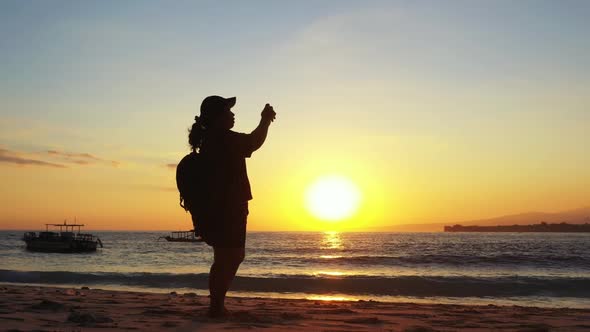 One girl tanning on tranquil resort beach trip by shallow ocean with white sandy background of the M