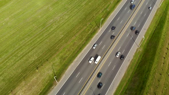 Aerial View From a Drone on an Asphalt Road, a Highway Divided By a Zone with Cars and Other