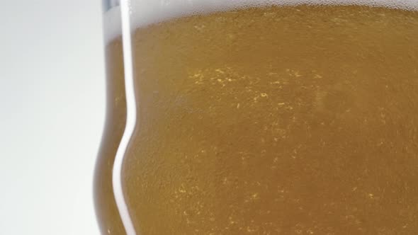 Foaming Beer is Poured Into the Glass in Slow Motion