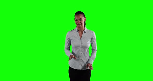 a Caucasian woman in suit talking in a green background