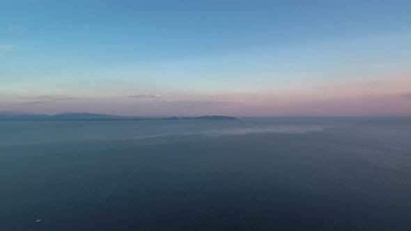 Sunset in Mesologgi Greece. Aerial view of the sunset behind clouds and sea horizon.