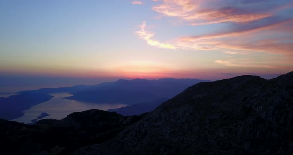 Aerial drone view of a sunset above a lake in Montenegro