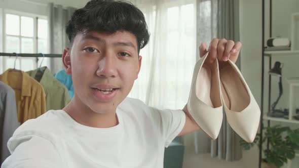 Asian Man Online Seller Recommending Kitten Heels And Recording Video While Selling Shoes