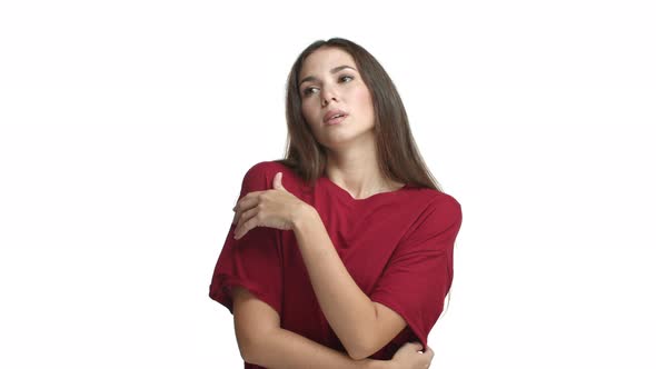 Young Upset Female Model in Red Tshirt Looking Uneasy and Distressed Sighing and Looking Gloomy at