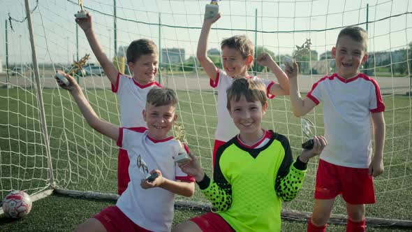 Winning Football Team of Little Boys Is Demonstrating Rewards on Stadium