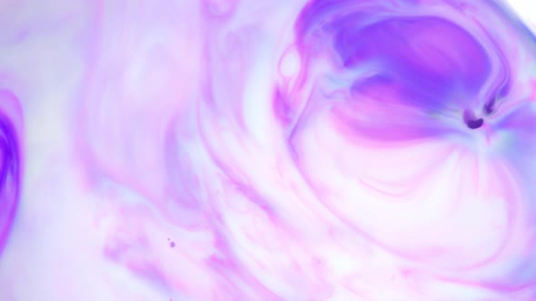 Ink in Water. Purple Ink Reacting in Water Creating Abstract Background.