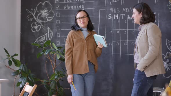 Cheerful Woman Chatting with Male Colleague