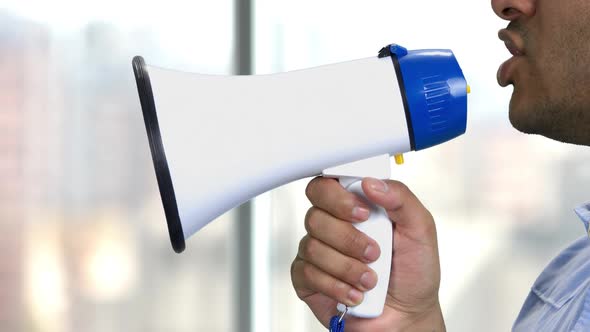 Close Up Man Talking Into Megaphone.