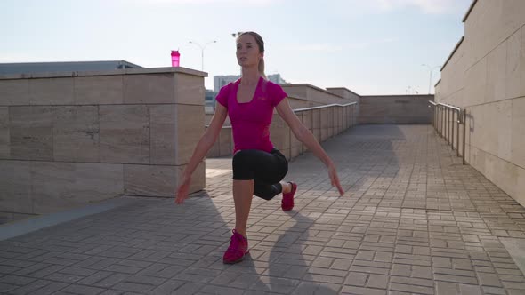 Young Woman Doing Cool Down Exercises After Training