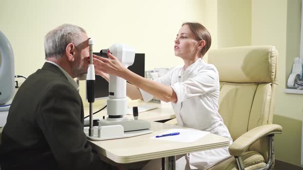 Ophthalmologist Examination of Elderly Man on Corneo Topographer