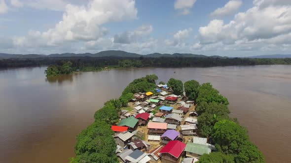 Aerial drone footage flying over unique remote island village in the Amazon South America.