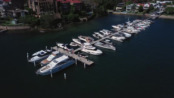 Sydney Harbor on a beautiful sunny day from Double Bay featuring boats, blue sky and water. Drone or