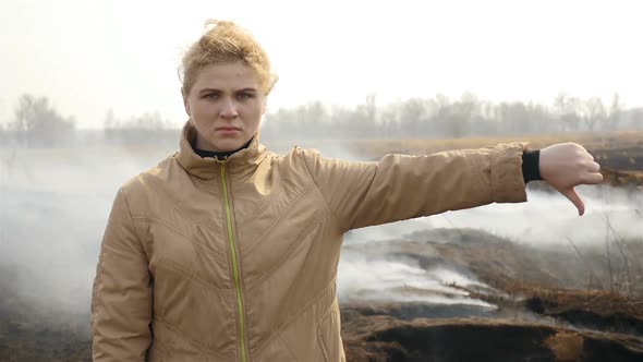 A Disgruntled Girl Stands Near a Steaming Field