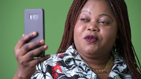 Overweight Beautiful African Woman Against Green Background