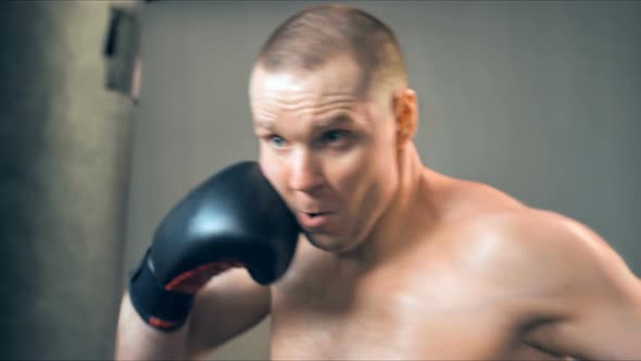 Young Male Athlete Training in Boxing Gym