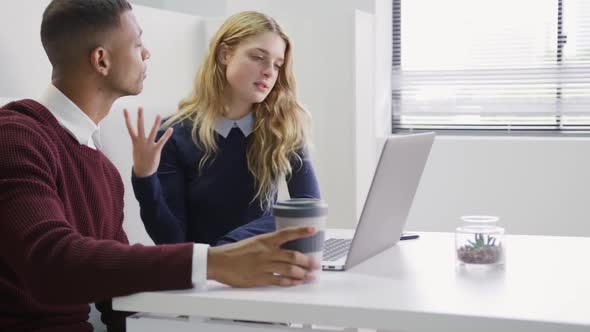 Man and woman discussing at the office