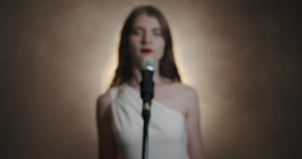 The Girl Singer Approaches the Microphone and Begins To Sing, the Scene in Smoke