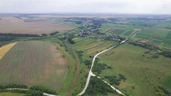 Aerial Above View of Fields and Village House Land Cars Driving on the Road