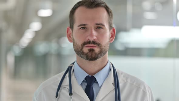 Portrait of Serious Male Doctor Looking at the Camera 