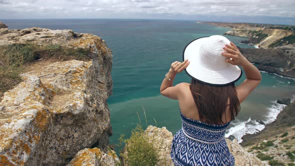 Woman Sitting on the Rock and Watching Seascape