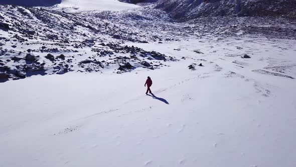 One Climber Is Walking Among the Snowy Mountains