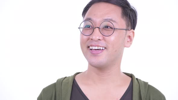 Face of Happy Japanese Man with Eyeglasses Thinking