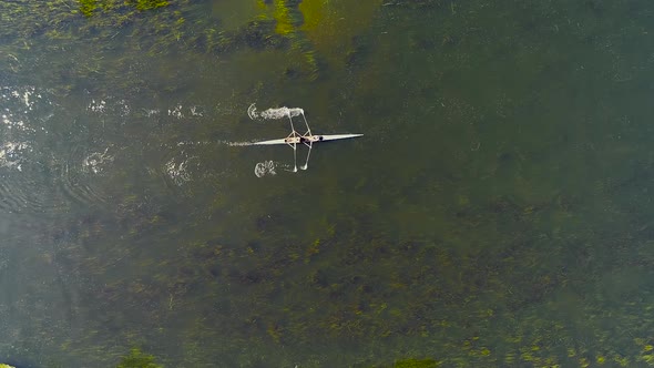 Aerial View Of Water Surface With White Kayak Passing By