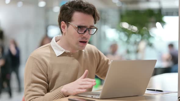 Young Male Designer Having Loss on Laptop in Office