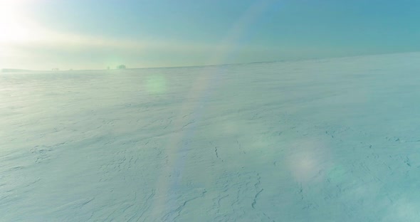 Aerial View of Cold Winter Landscape Arctic Field Trees Covered with Frost Snow Ice River and Sun