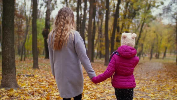 Mom and Little Girl Spending Leisure in Autumn Park