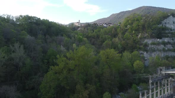 abandoned cement factory monument in the middle of nature drone 4k