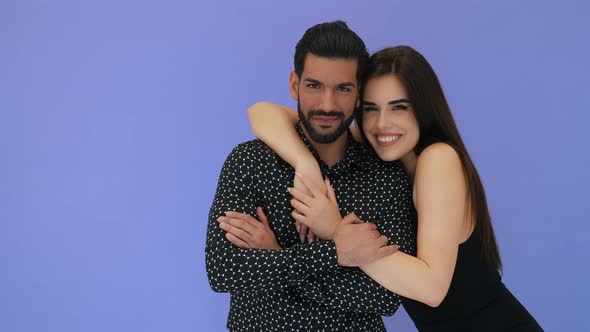 Attractive Young Adult Heterosexual Couple Hugging Smiling and Looking at Camera