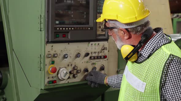 Senior Factory Worker Teach How to Use Machine Equipment in the Factory Workshop