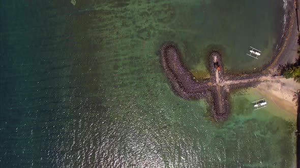 Aerial view of the blue water coast line and pier in Candidasa Beach, Bali, Indonesia