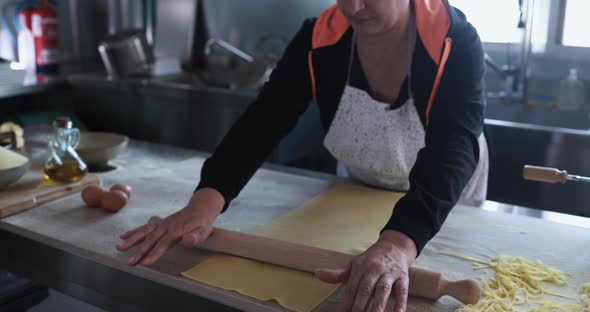 Woman working inside pasta factory