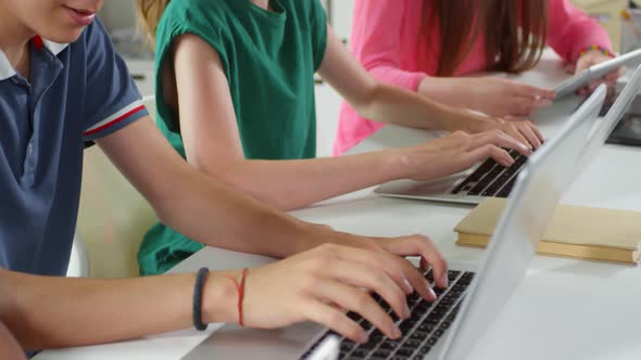 Teenagers Typing on Keyboards