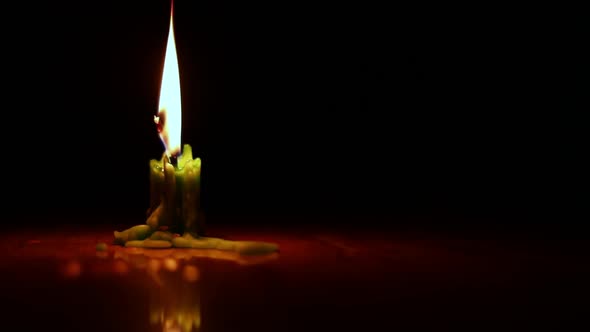 a candle burning in the dark, beautiful fire of a candle in a dark room