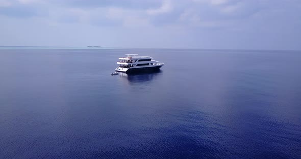 Tropical drone copy space shot of a sunshine white sandy paradise beach and blue water background in