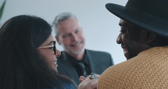 Close up shot of multi ethnic couple holding keys to new home over shoulder view