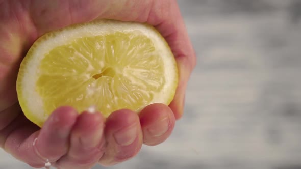 Squeezing a lemon with splashes and drops 