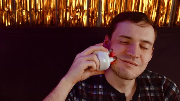 Young Happy Man Using 3d Massager for Face