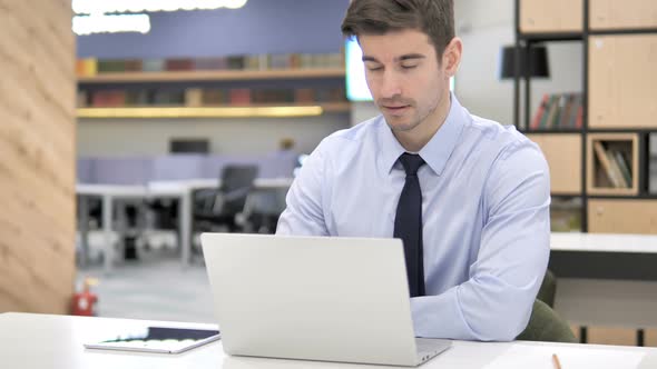 Thinking Businessman Working in Office