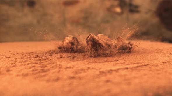 Super Slow Motion Pile of Truffles Falls on the Table with Cocoa