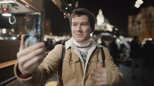 Man Blogger Recording Himself on Phone at Xmas Time