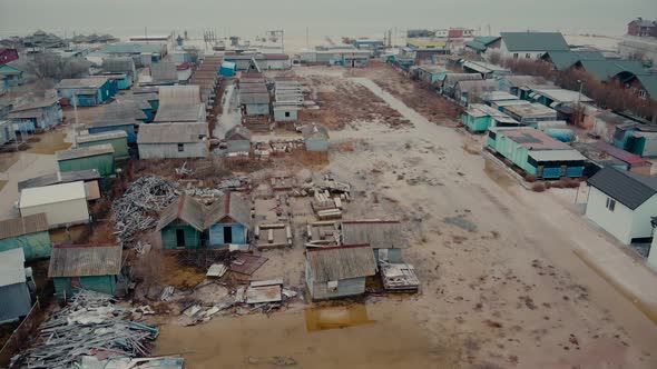 Waterlogged Village with Cottage Buildings and Garbage