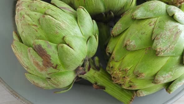 Whole Fresh Artichokes on Plate