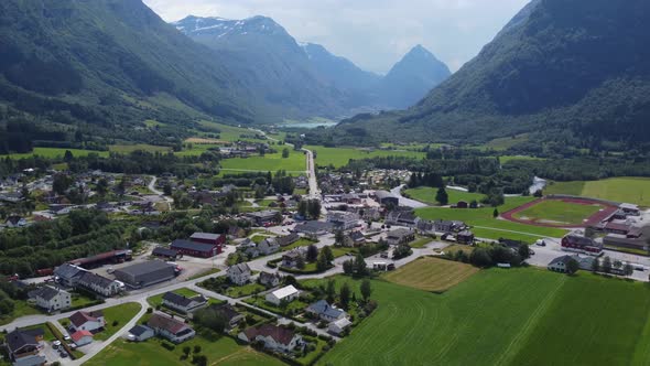 General sunny day overview of Byrkjelo town-center with road E39 passing through - Cozy Norway villa